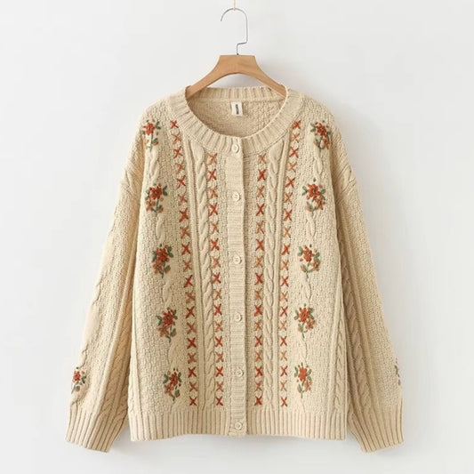 Beige cardigan with floral embroidery on a white background