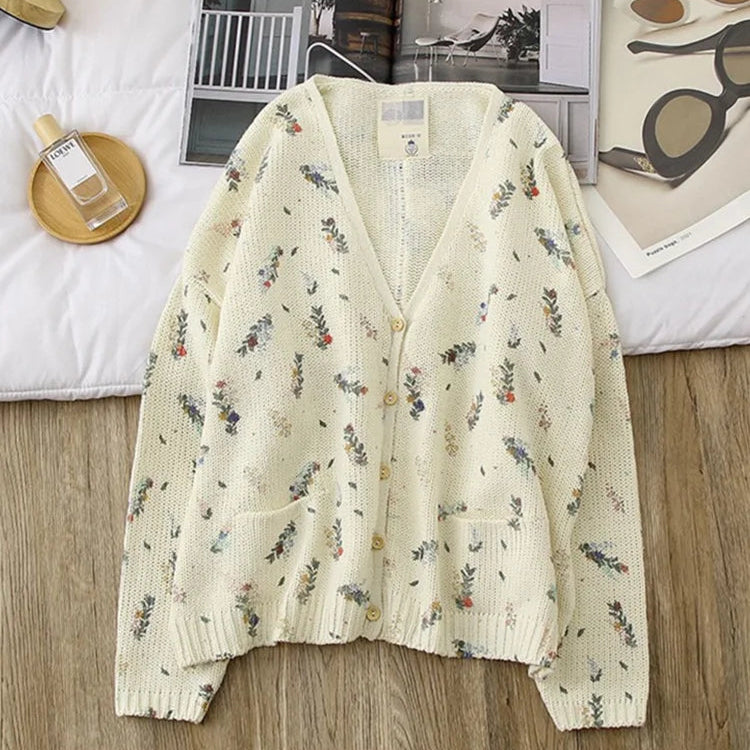 Floral patterned cardigan on a wooden floor with a blurred background