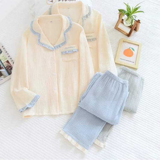 Beige and light blue pajama set on a white surface with decorative items.