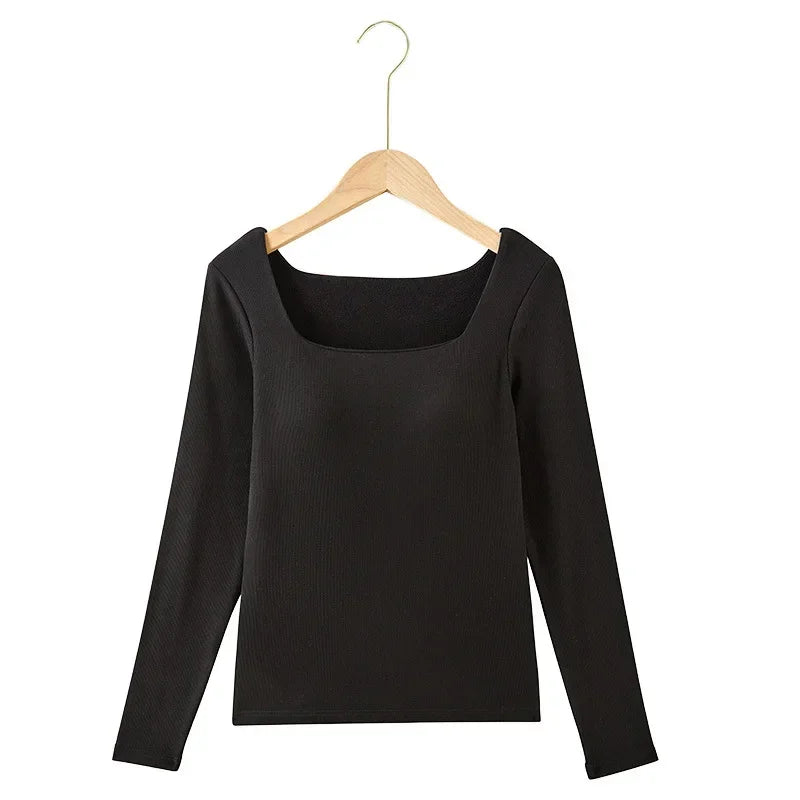 Black long-sleeve top on a wooden hanger against a white background