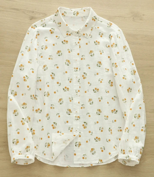 White blouse with small floral pattern on a wooden surface