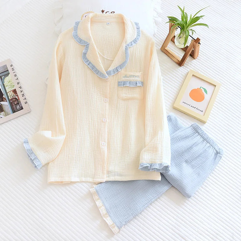 Light-colored pajama set with blue accents on a white surface.