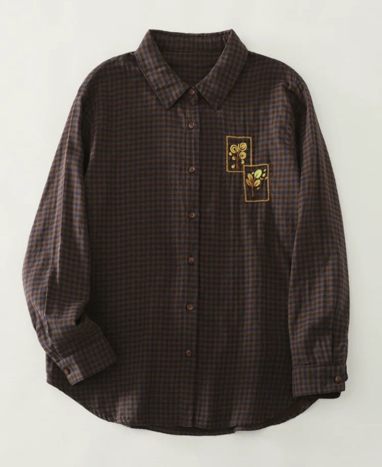 Plaid shirt with embroidered design on a white background