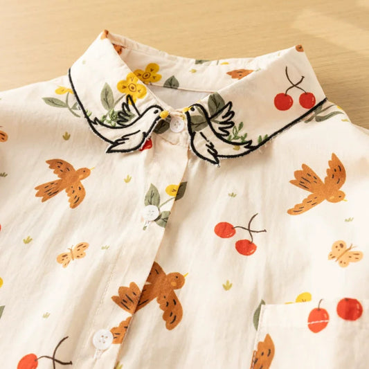 Unique shirt with bird and cherry pattern on a white background