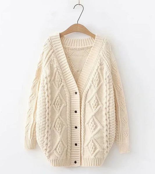 Beige knitted cardigan on a hanger against a white background