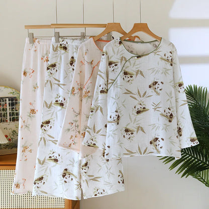 Set of pajama pants and top with panda and bamboo pattern on a hanger against a neutral background.