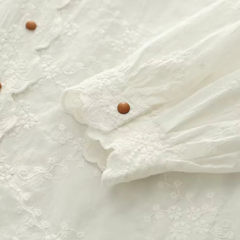 Close-up of a white textured fabric with brown buttons on a light background