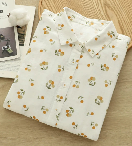 Floral patterned shirt on a wooden surface with a magazine underneath