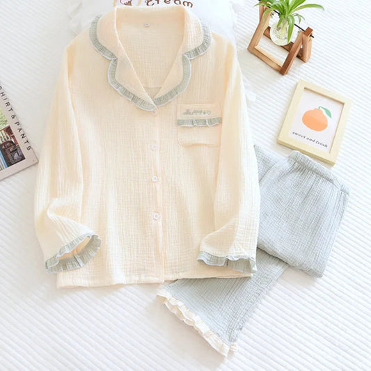 Beige pajama set with gray trim on a white surface