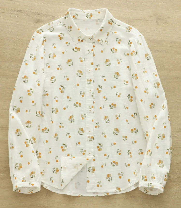 White blouse with small floral pattern on a wooden surface