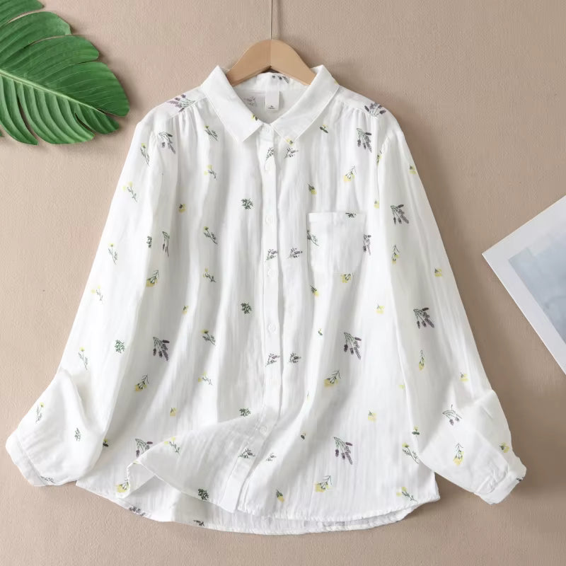 White blouse with floral pattern on a beige background