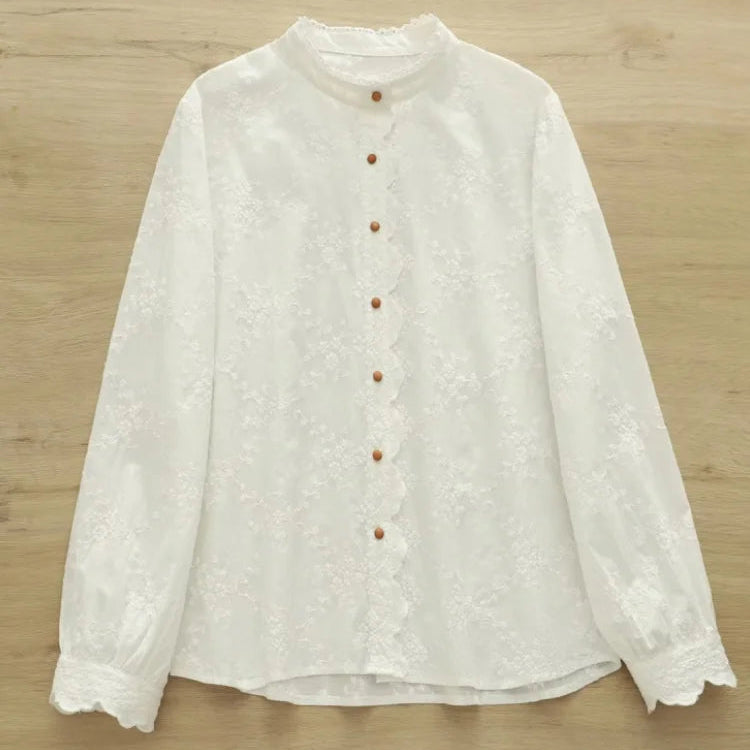 White blouse with buttons on a wooden surface