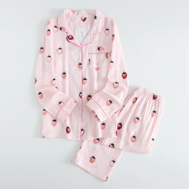 Pink pajama set with strawberry pattern on a light gray background