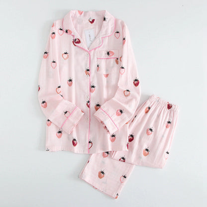 Pink pajama set with strawberry pattern on a light gray background