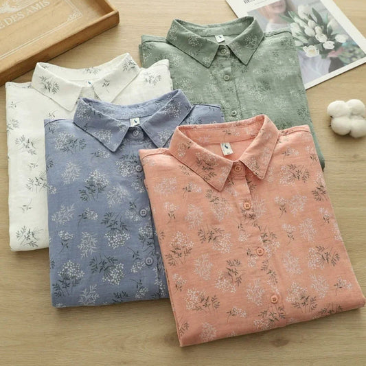 Four folded shirts in different colors on a wooden surface