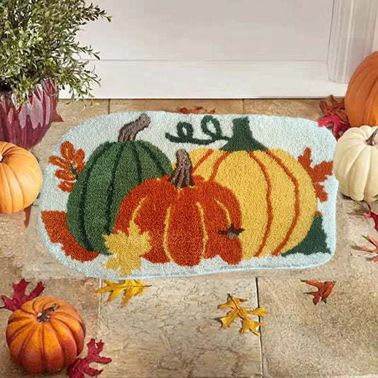 Decorative doormat with pumpkins and leaves on a wooden floor.